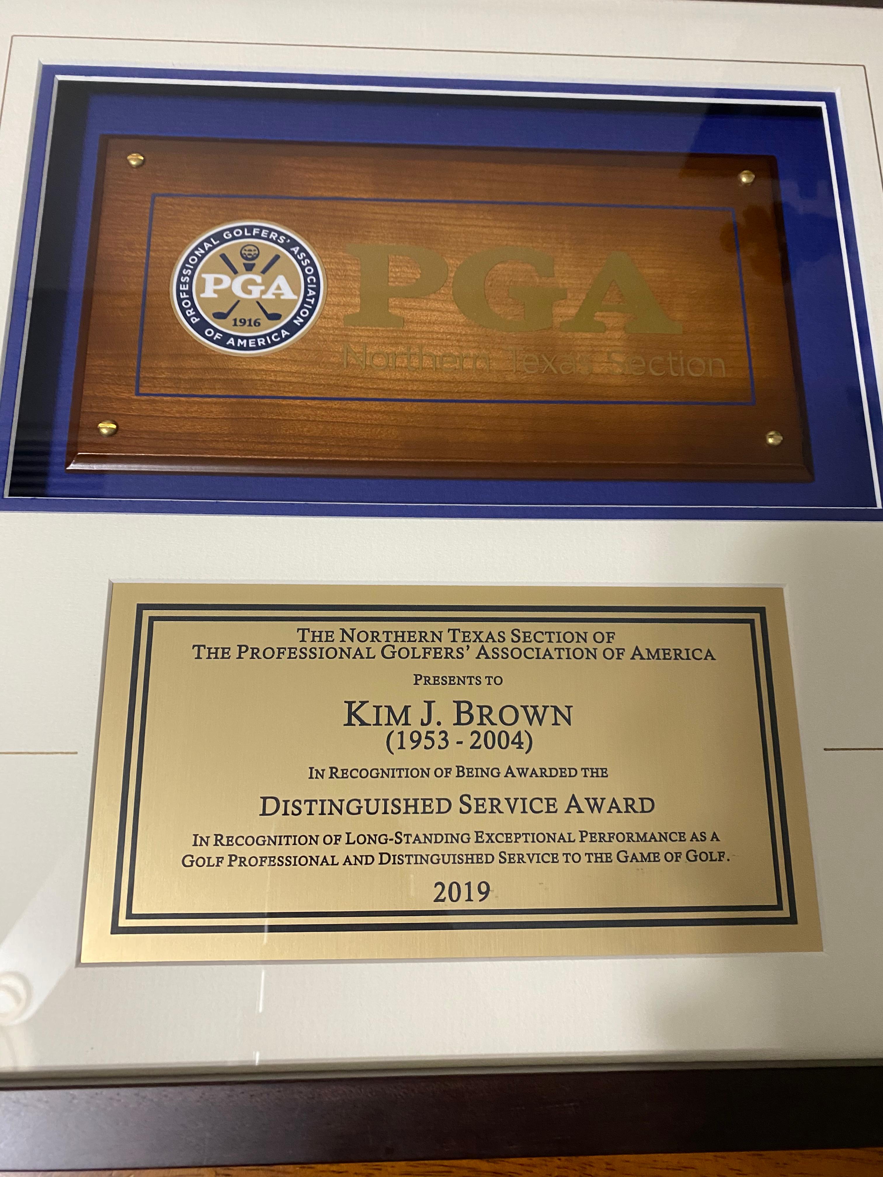Framed Northern Texas PGA plaque presenting the Distinguished Service Award to Kim J. Brown (1953-2004) in 2019